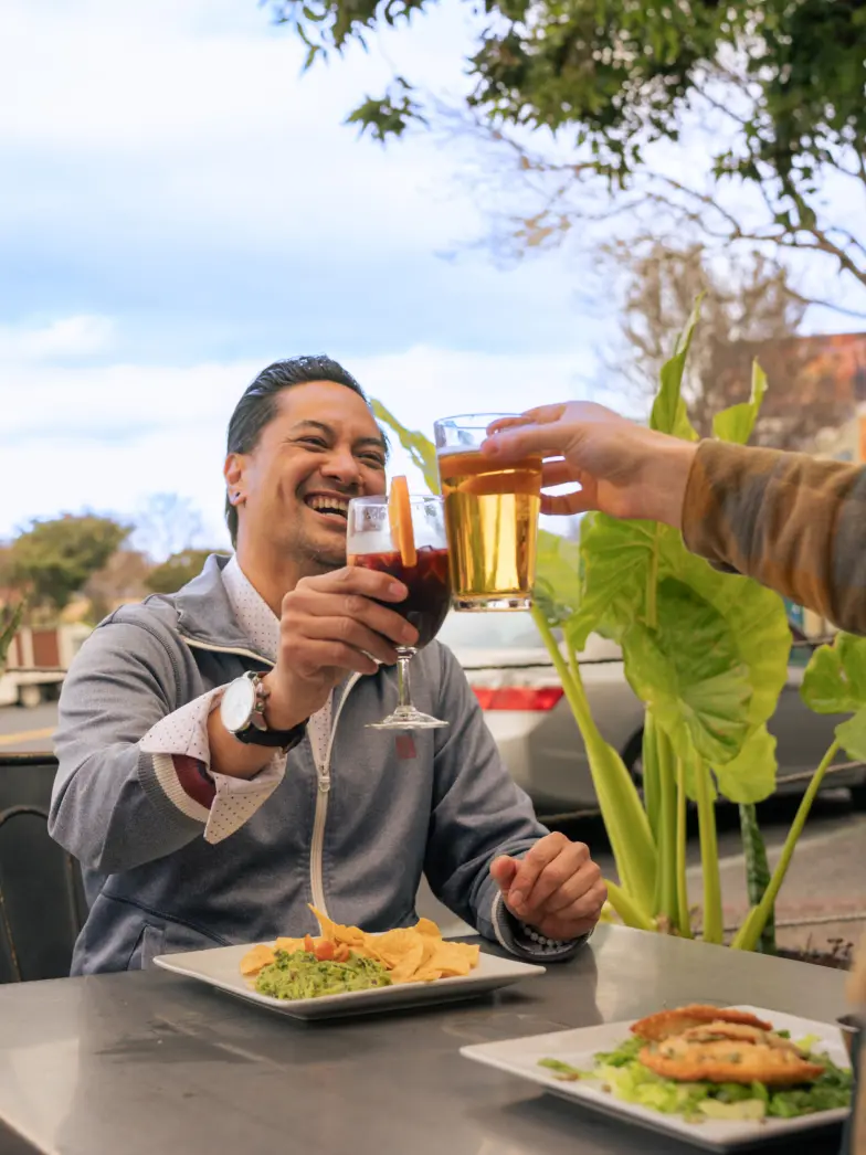 Men Clinking Beverages in Cheers with Grand Avenue in Background San Francisco | Brand New Luxury Apartments