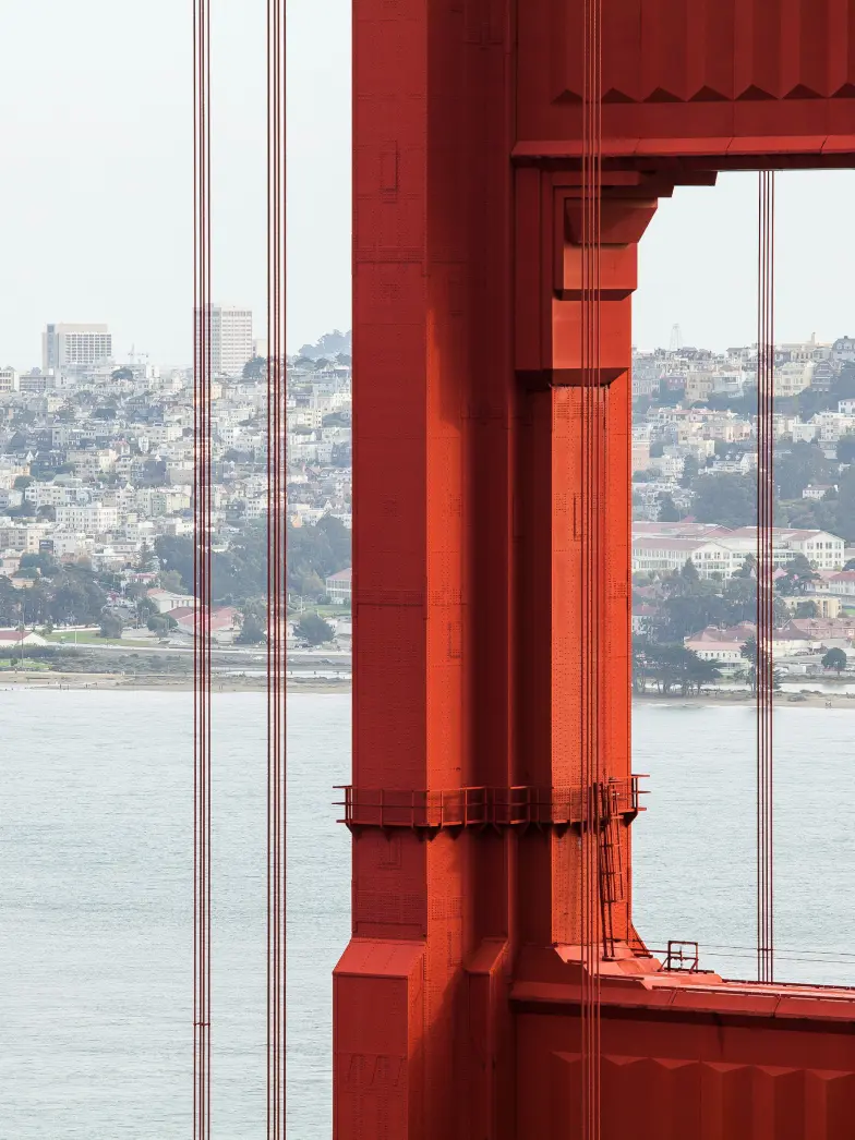 Close Up of Pillar on Golden Gate Bridge with San Francisco in Background | Brand New Luxury Apartments